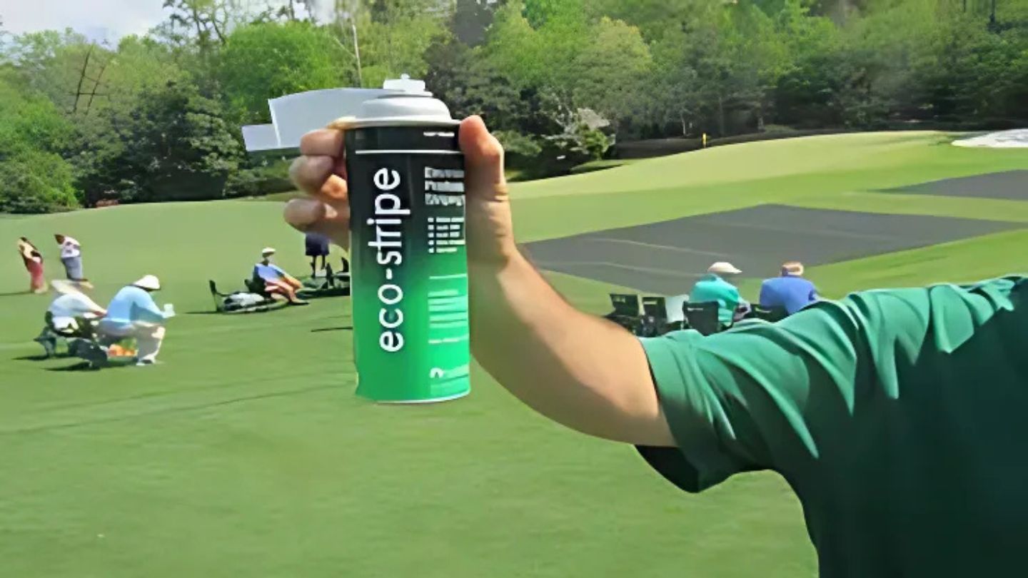 Expert Holding Eco-Stripe Spray Can on Grass