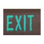 Exit Sign Glowing In Green In Dark Environment