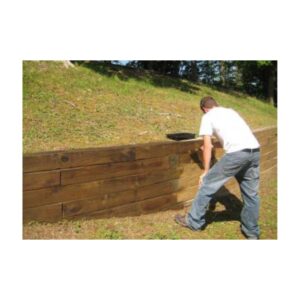 Man Applying Wood Stain To Large Outdoor Wooden Panel