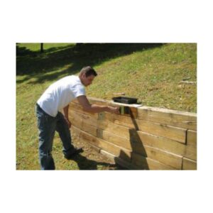 Person Building Or Stacking Wooden Planks Outdoors
