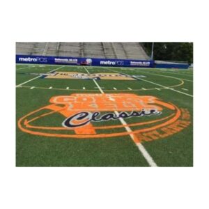 Football field event logo painted on synthetic turf football field.