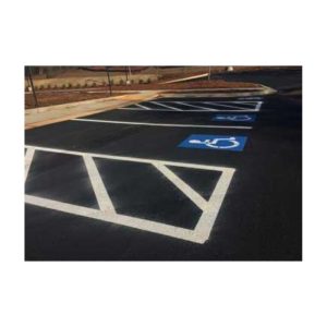 Parking Lot With White Striped Spaces And A Blue Handicapped Symbol