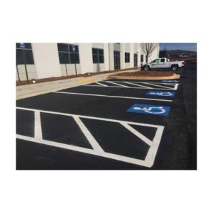 Parking Lot With White Striped Spaces And A Handicapped Symbol