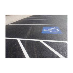 Parking Lot With White Striped Spaces And A Blue Handicapped Symbol